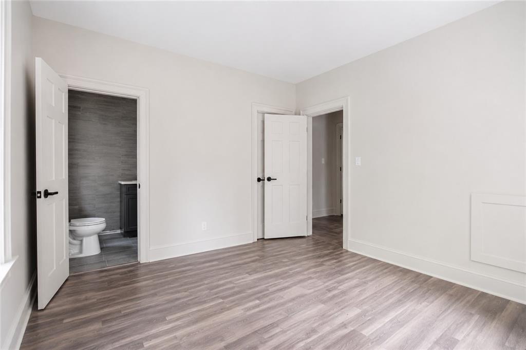 665 Lexington Avenue Southwest Atlanta, GA 30310 - Photo 13 of 33 an empty room with wooden floor and a toilet