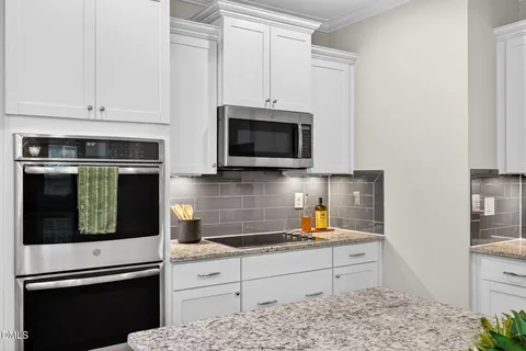 a kitchen with stainless steel appliances a refrigerator sink and cabinets