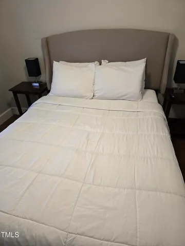 a large white bed in a small room