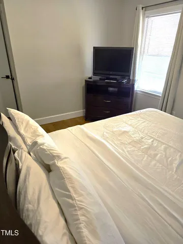 a bedroom with a bed and television