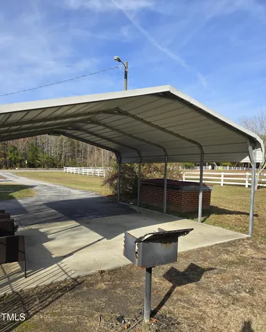 a backyard of a house with table and chairs