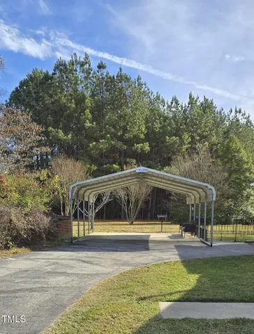 a view of a swimming pool and trees in the background