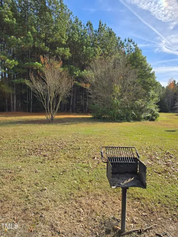 a view of a swimming pool with a table and chairs under an umbrella