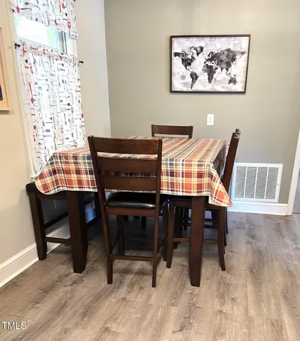 a view of a dining room with furniture window and wooden floor