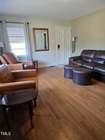 a room with furniture rug and window