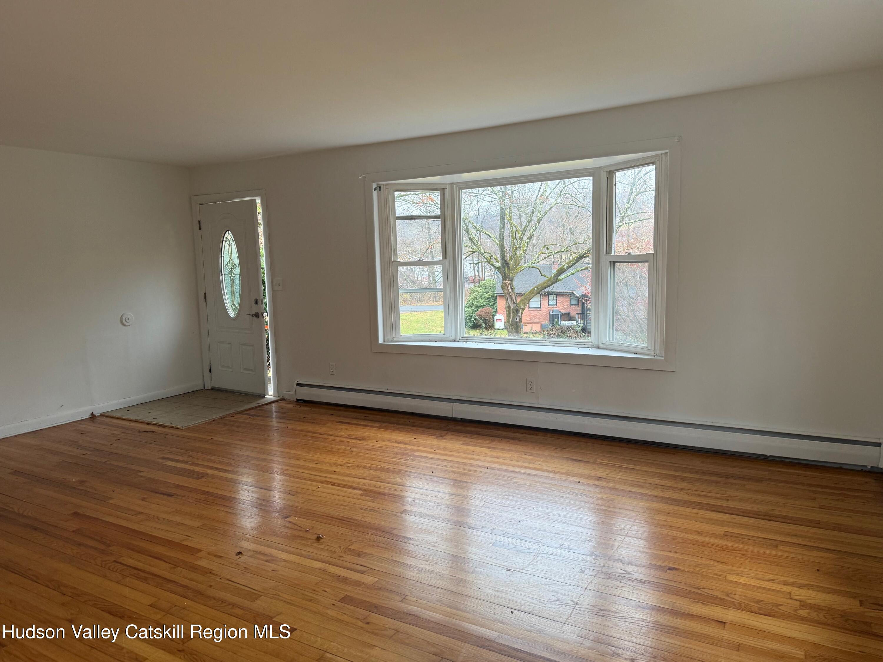 6 Van Orden Road Milton, NY 12547 - Photo 4 of 21 an empty room with wooden floor and windows