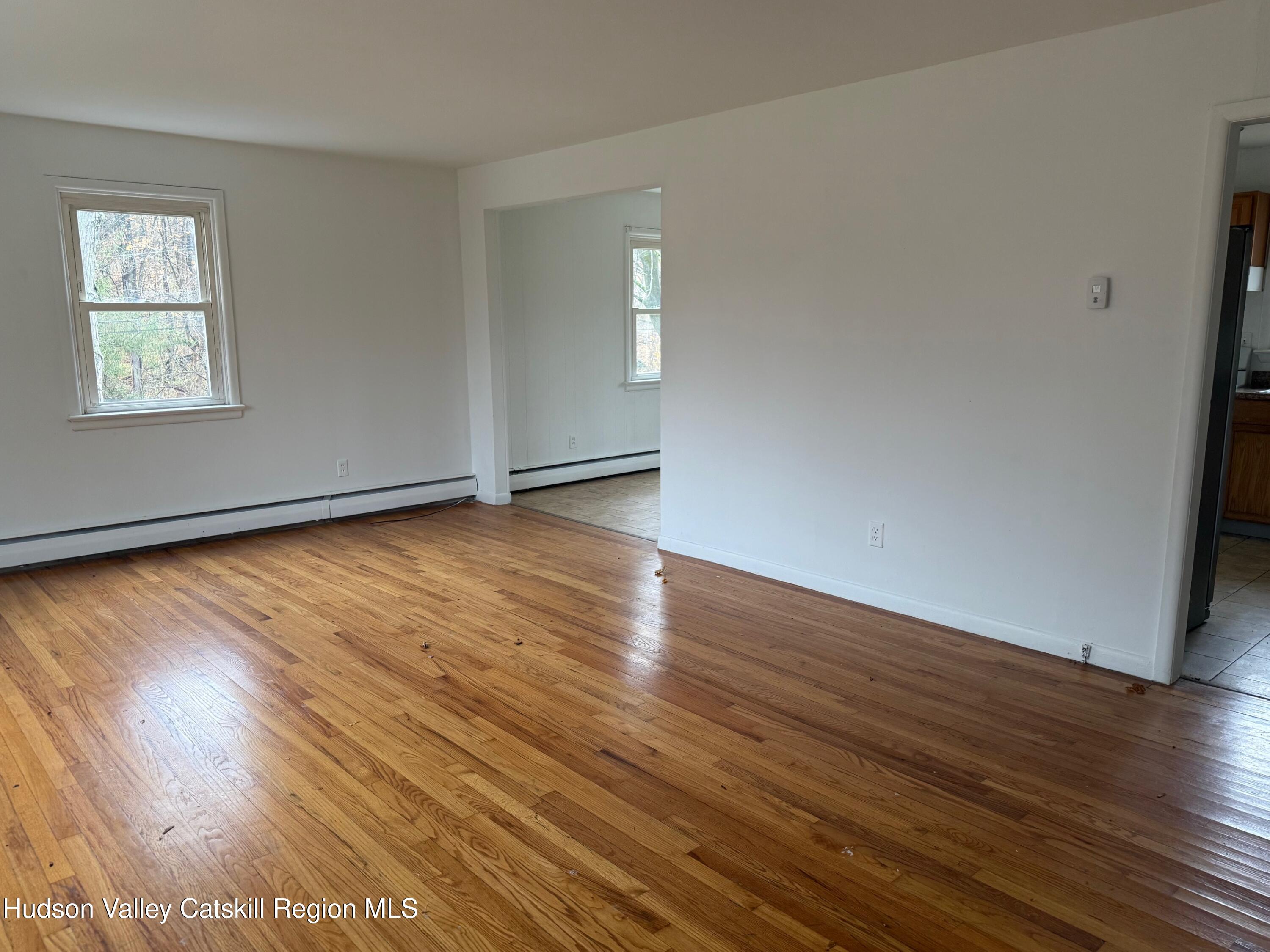 6 Van Orden Road Milton, NY 12547 - Photo 5 of 21 a view of an empty room with wooden floor and a window