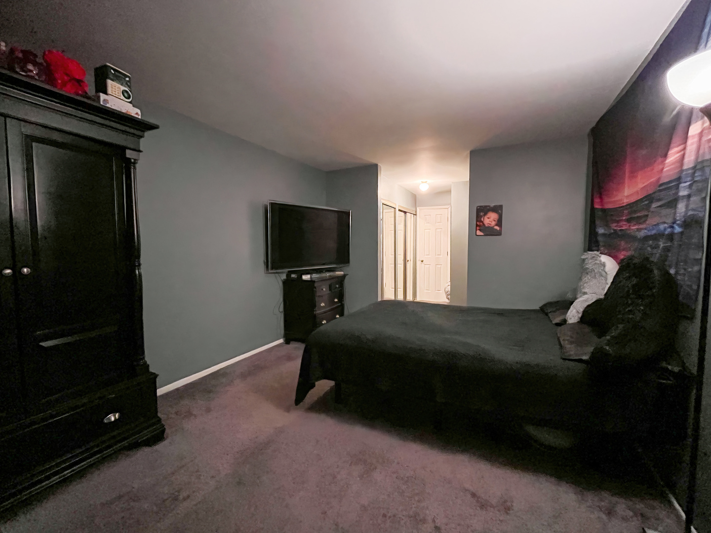 1313 A South Rebecca Road, Unit 218 Lombard, IL 60148 - Photo 12 of 19 a bedroom with a bed and a flat tv screen on a dresser