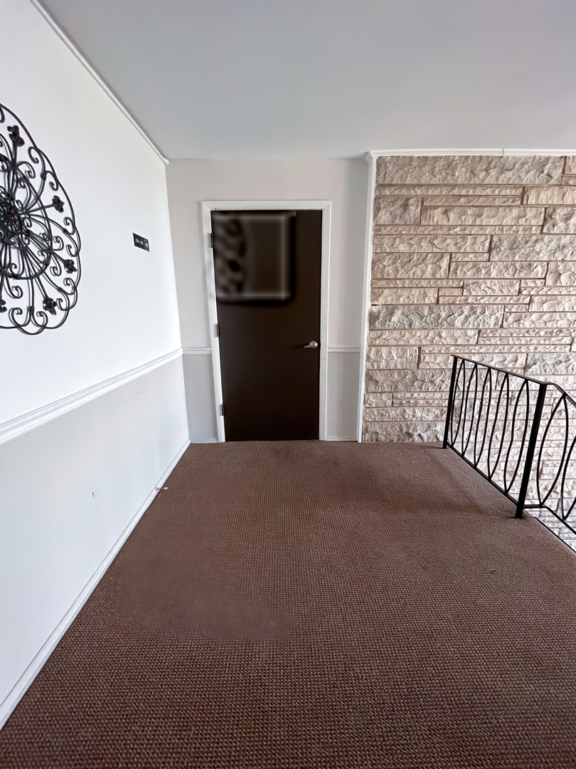 1313 A South Rebecca Road, Unit 218 Lombard, IL 60148 - Photo 5 of 19 a bedroom with a bed and a table