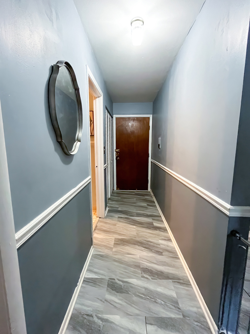 1313 A South Rebecca Road, Unit 218 Lombard, IL 60148 - Photo 7 of 19 a view of a hallway with wooden floor and staircase