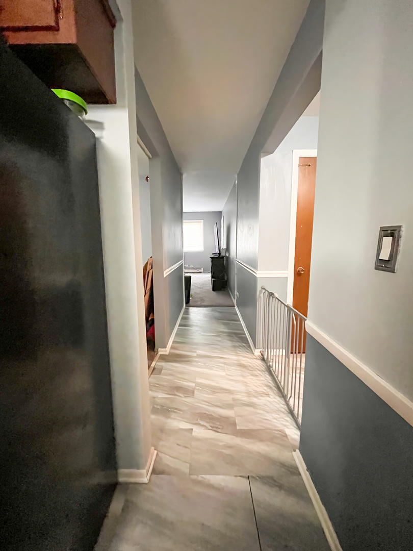 1313 A South Rebecca Road, Unit 218 Lombard, IL 60148 - Photo 8 of 19 a view of a hallway with windows