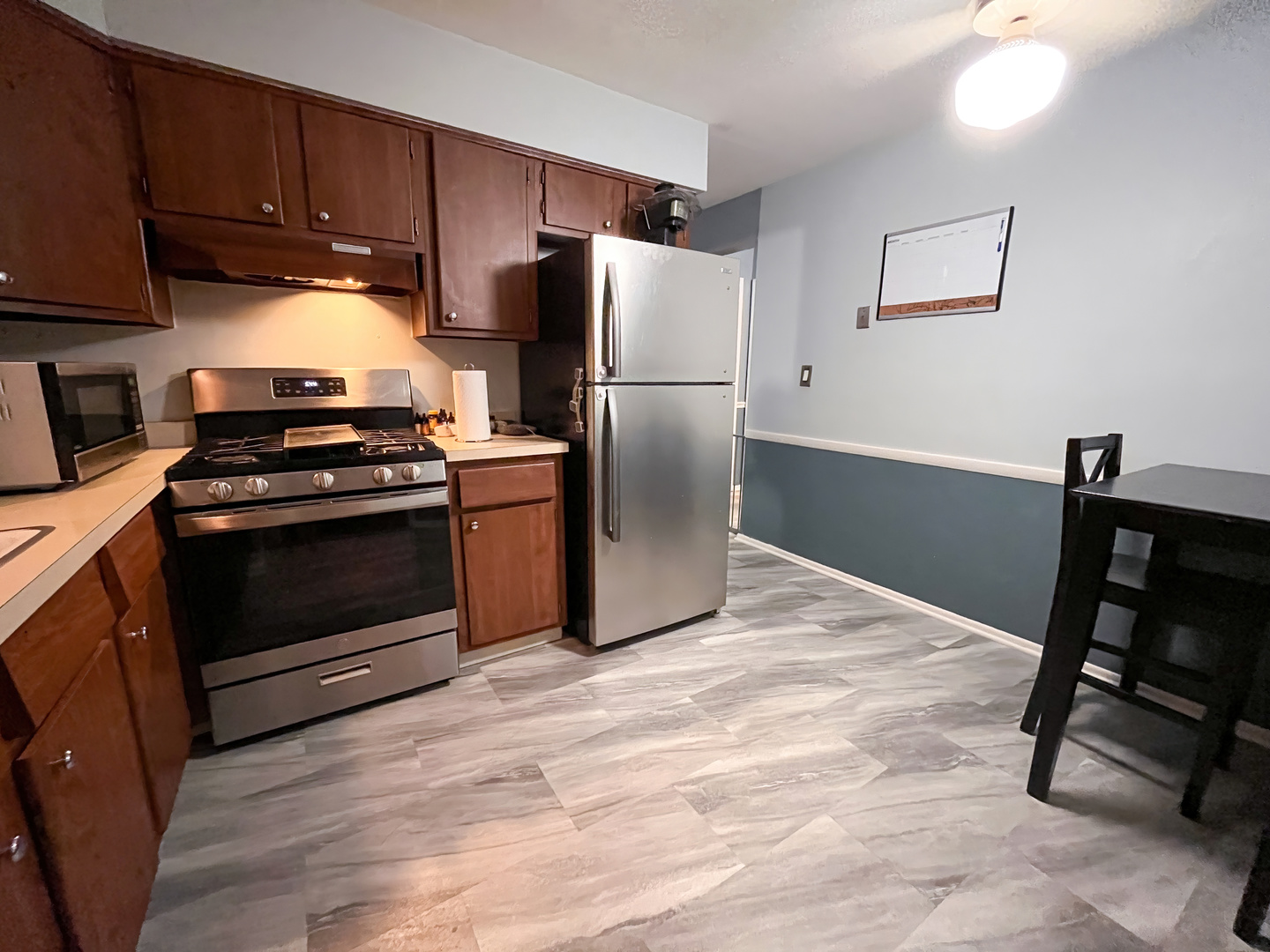 1313 A South Rebecca Road, Unit 218 Lombard, IL 60148 - Photo 9 of 19 a kitchen with granite countertop a stove a refrigerator and a stove top oven