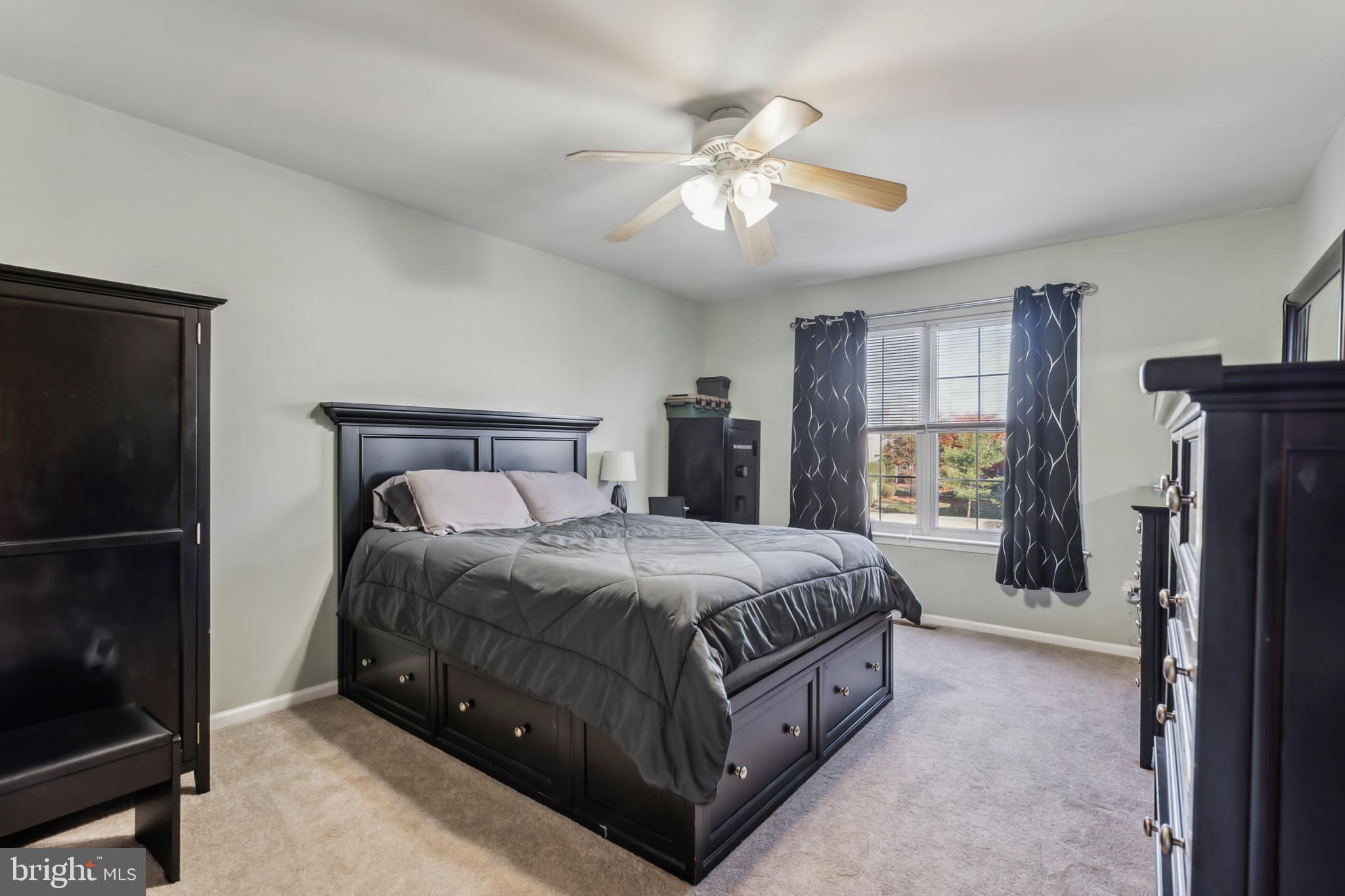 1102 Coventry Way Mount Laurel, NJ 08054 - Photo 17 of 24 a spacious bedroom with a bed and a chandelier