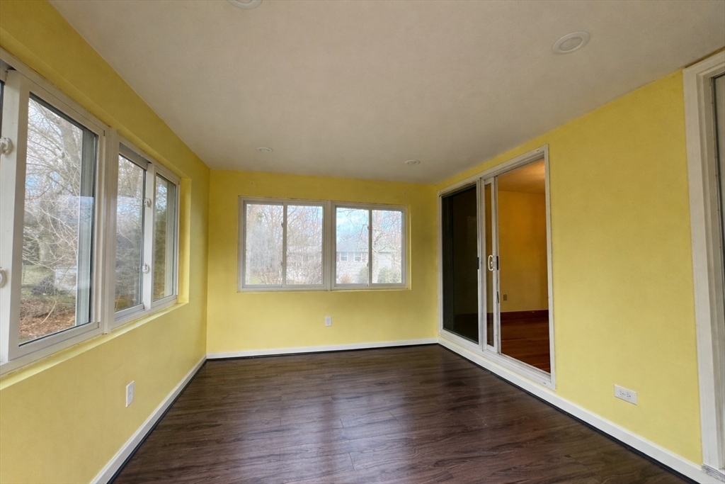 7 Lee Street Walpole, MA 02081 - Photo 9 of 24 a view of an empty room with wooden floor and a window