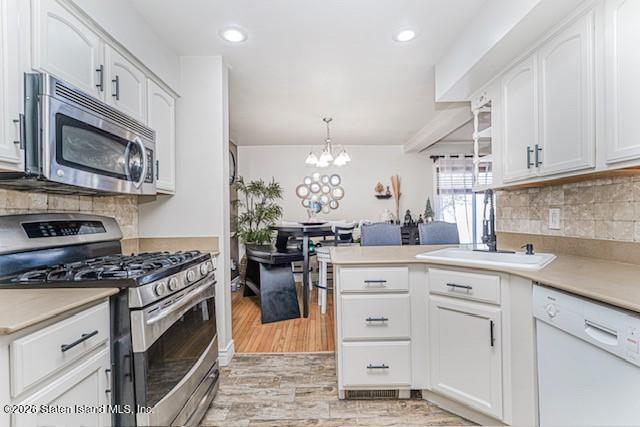 442 Ilyssa Way Staten Island, NY 10312 - Photo 11 of 25 a kitchen with stainless steel appliances granite countertop a stove a sink and a microwave