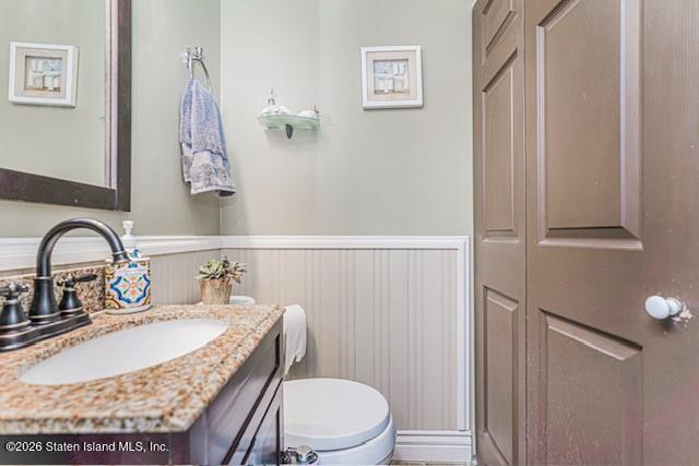 442 Ilyssa Way Staten Island, NY 10312 - Photo 13 of 25 a bathroom with a granite countertop sink a toilet and a mirror