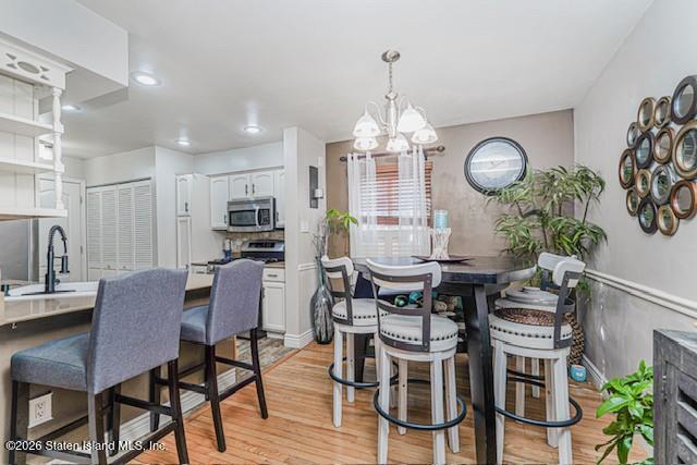 442 Ilyssa Way Staten Island, NY 10312 - Photo 7 of 25 a view of a dining room with furniture a chandelier and wooden floor