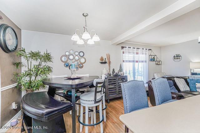 442 Ilyssa Way Staten Island, NY 10312 - Photo 8 of 25 a view of a dining room with furniture a chandelier and wooden floor