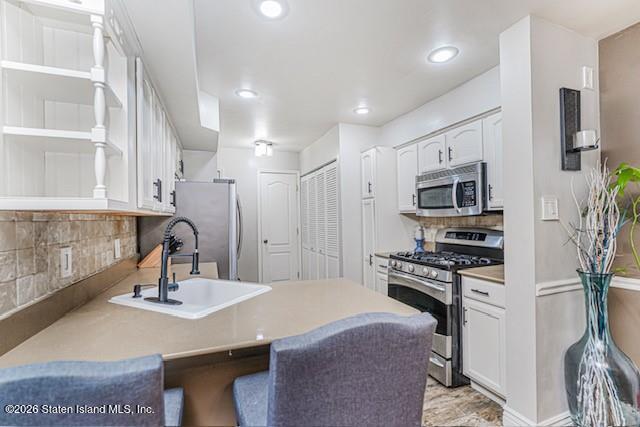 442 Ilyssa Way Staten Island, NY 10312 - Photo 9 of 25 a kitchen with stainless steel appliances a sink a microwave a stove and refrigerator
