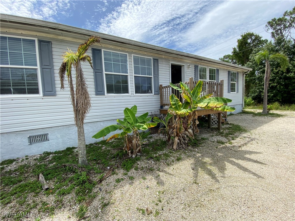 5527 Judith Road, Unit B Bokeelia, FL 33922 - Photo 1 of 8 a view of a house with backyard and sitting area