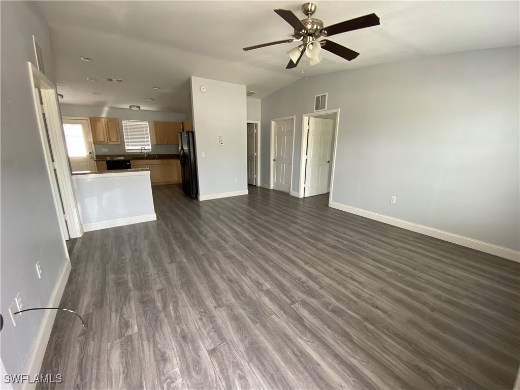 5527 Judith Road, Unit B Bokeelia, FL 33922 - Photo 3 of 8 a view of a living room hardwood floor and a ceiling fan