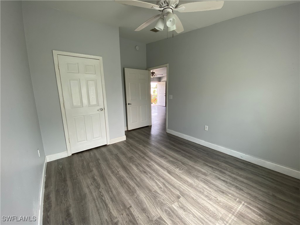 5527 Judith Road, Unit B Bokeelia, FL 33922 - Photo 7 of 8 wooden floor in an empty room with a window