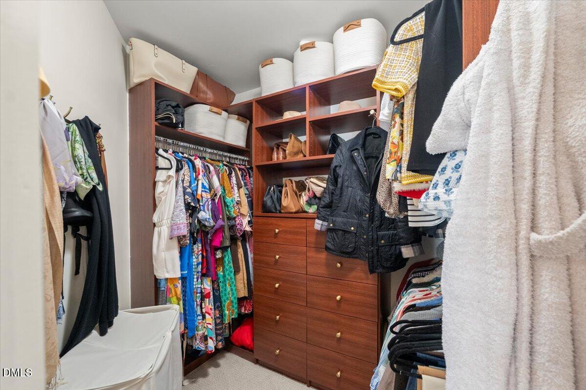 8449 Central Drive Raleigh, NC 27613 - Photo 24 of 38 a view of walk in closet with clothes and shoes