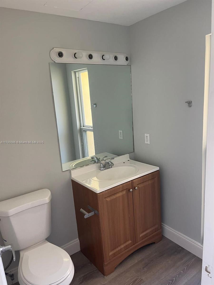 Boynton Beach Boynton Beach, FL 33435 - Photo 18 of 22 a bathroom with a sink a toilet and mirror