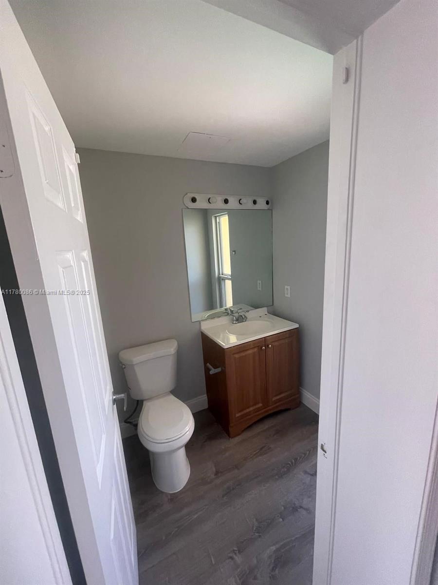 Boynton Beach Boynton Beach, FL 33435 - Photo 20 of 22 a bathroom with a toilet sink and mirror