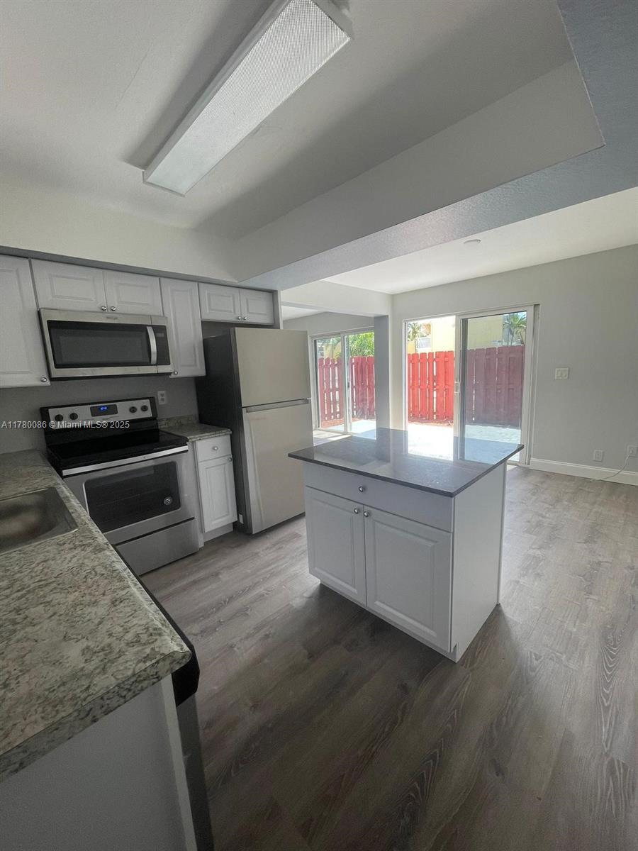 Boynton Beach Boynton Beach, FL 33435 - Photo 3 of 22 a kitchen with granite countertop a refrigerator and a stove