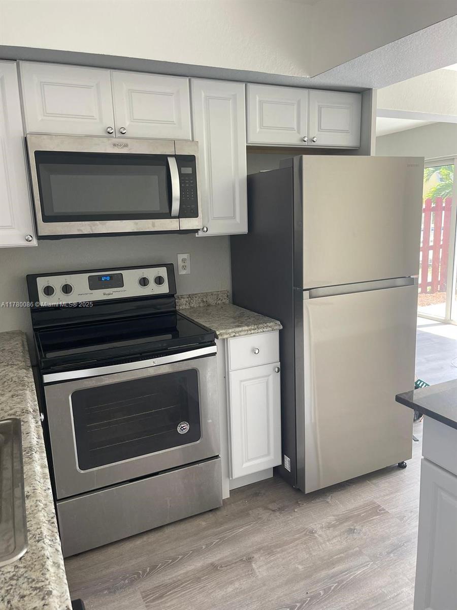 Boynton Beach Boynton Beach, FL 33435 - Photo 4 of 22 a kitchen with a stove microwave and refrigerator