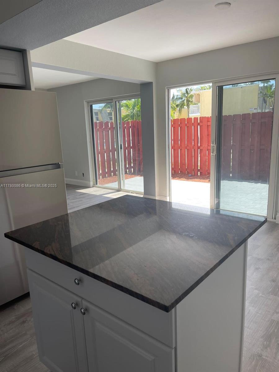 Boynton Beach Boynton Beach, FL 33435 - Photo 6 of 22 a kitchen with granite countertop a sink a stove and a granite counter top
