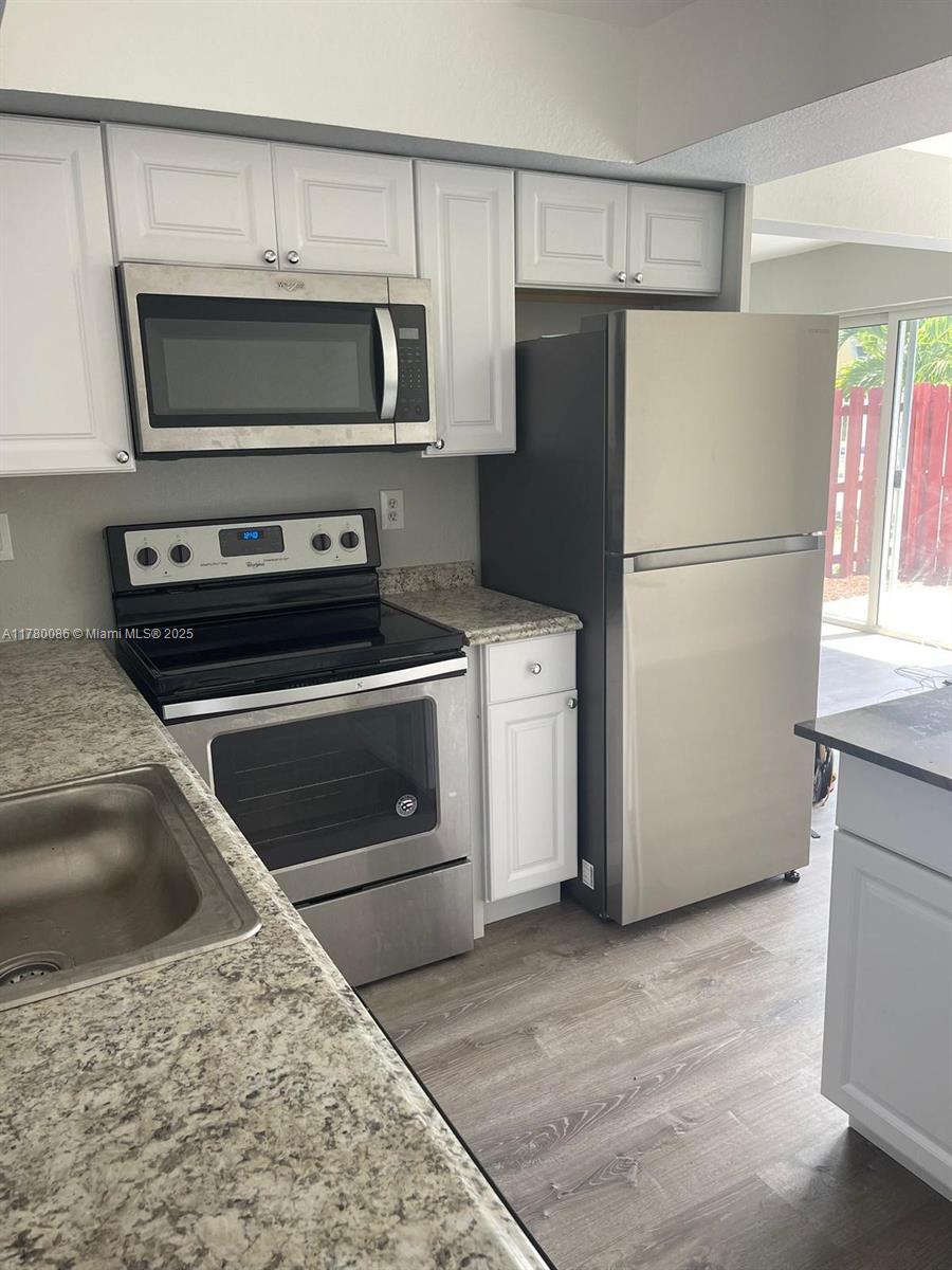 Boynton Beach Boynton Beach, FL 33435 - Photo 9 of 22 a kitchen with a refrigerator stove and microwave
