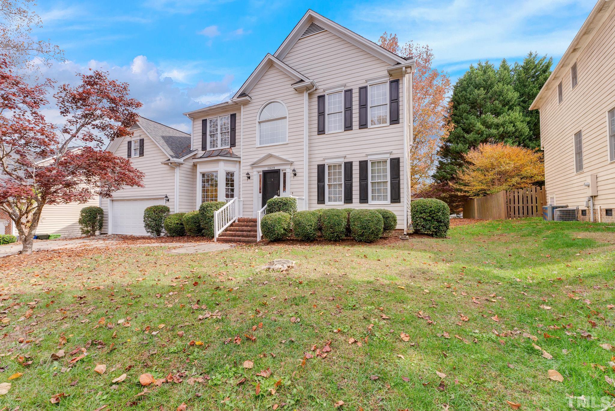 11619 Shavenrock Place Raleigh, NC 27613 - Photo 1 of 20 a front view of a house with a yard and trees
