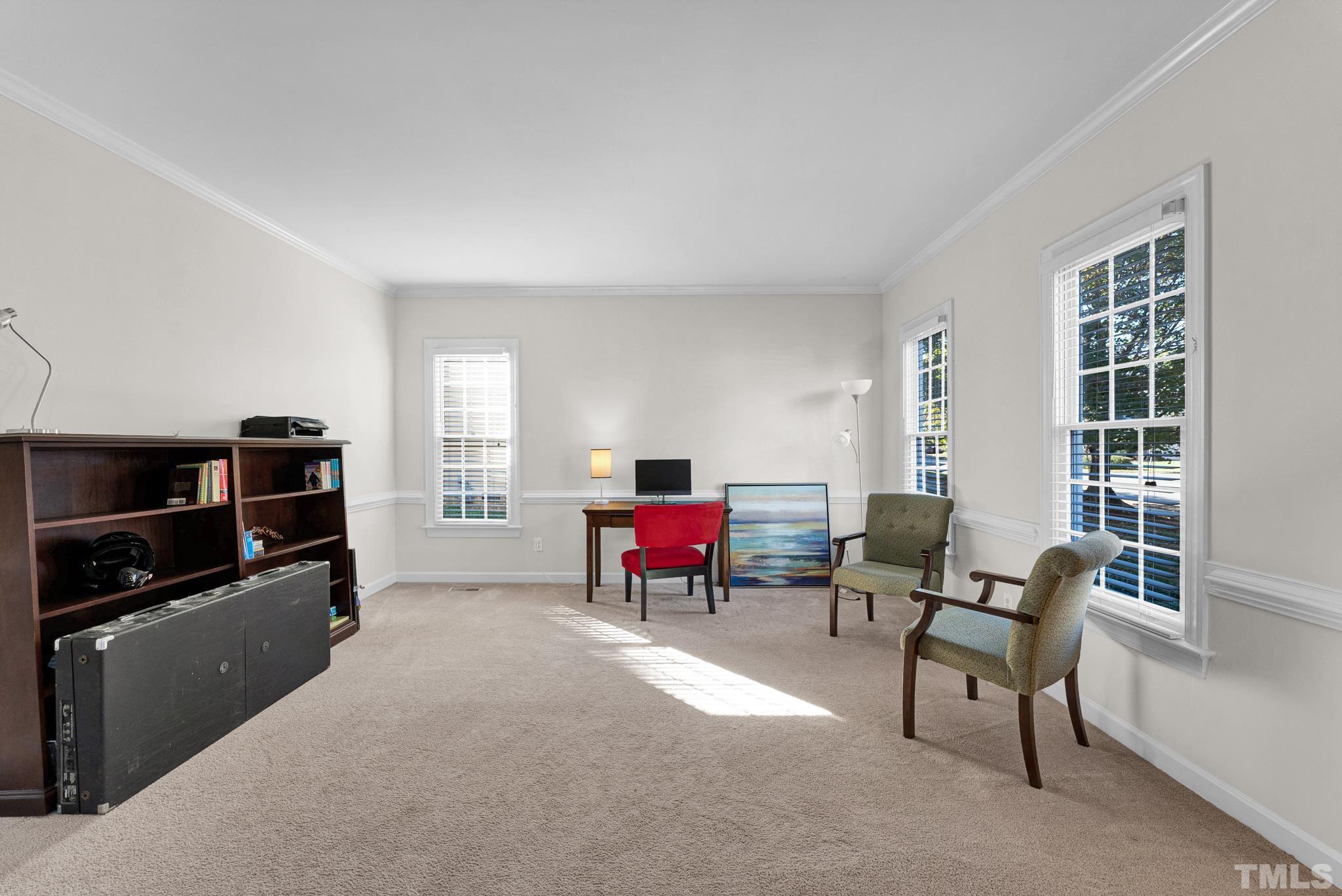 11619 Shavenrock Place Raleigh, NC 27613 - Photo 11 of 20 a living room with furniture and a flat screen tv