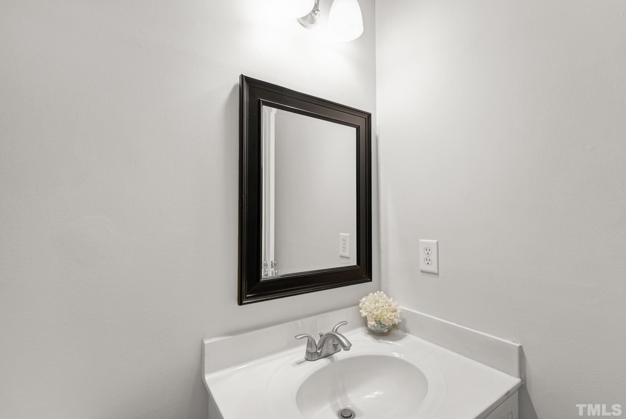 11619 Shavenrock Place Raleigh, NC 27613 - Photo 12 of 20 a bathroom with a sink and a mirror