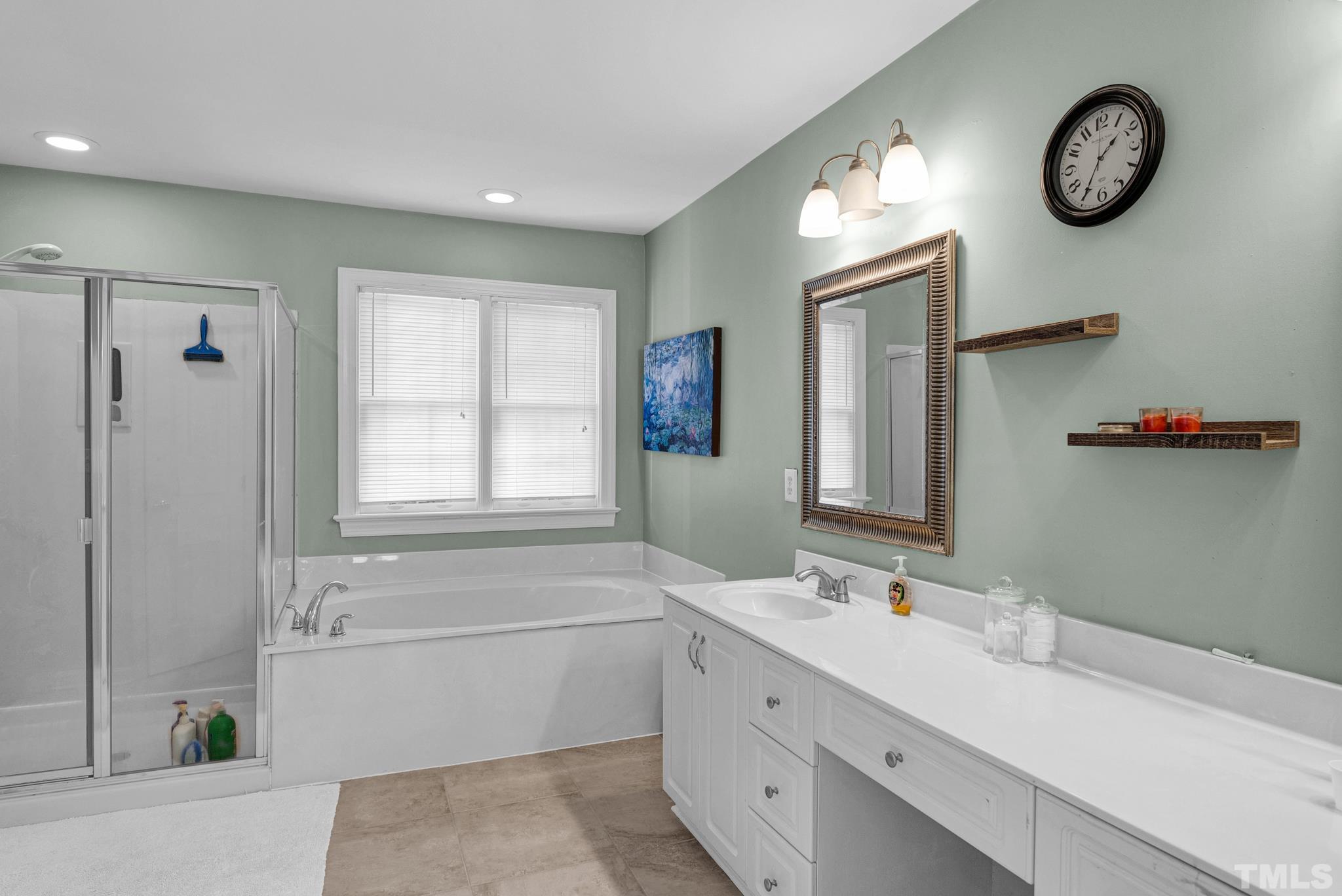 11619 Shavenrock Place Raleigh, NC 27613 - Photo 14 of 20 a bathroom with a double vanity sink mirror and bathtub