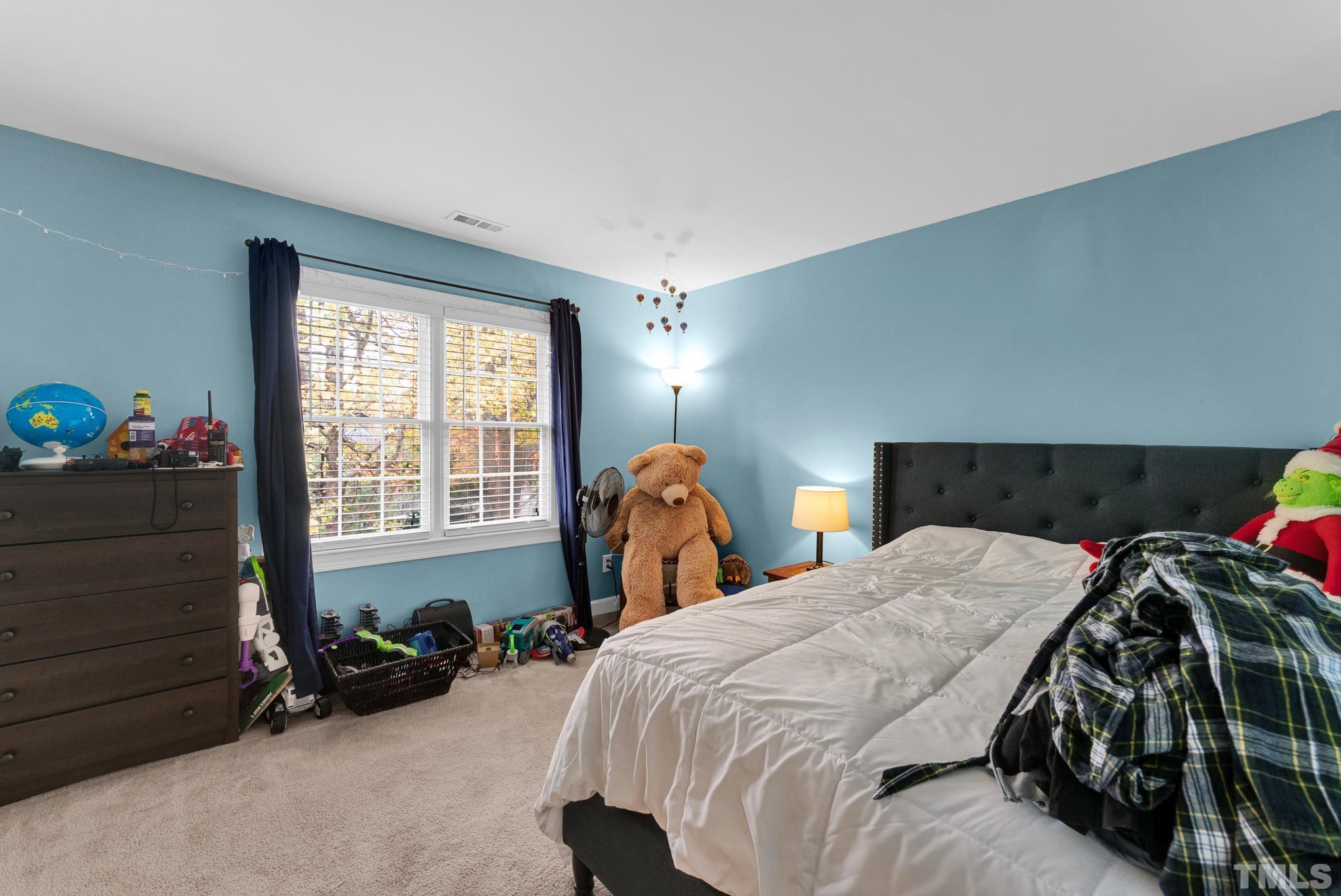 11619 Shavenrock Place Raleigh, NC 27613 - Photo 15 of 20 a bed sitting in a bedroom next to a window
