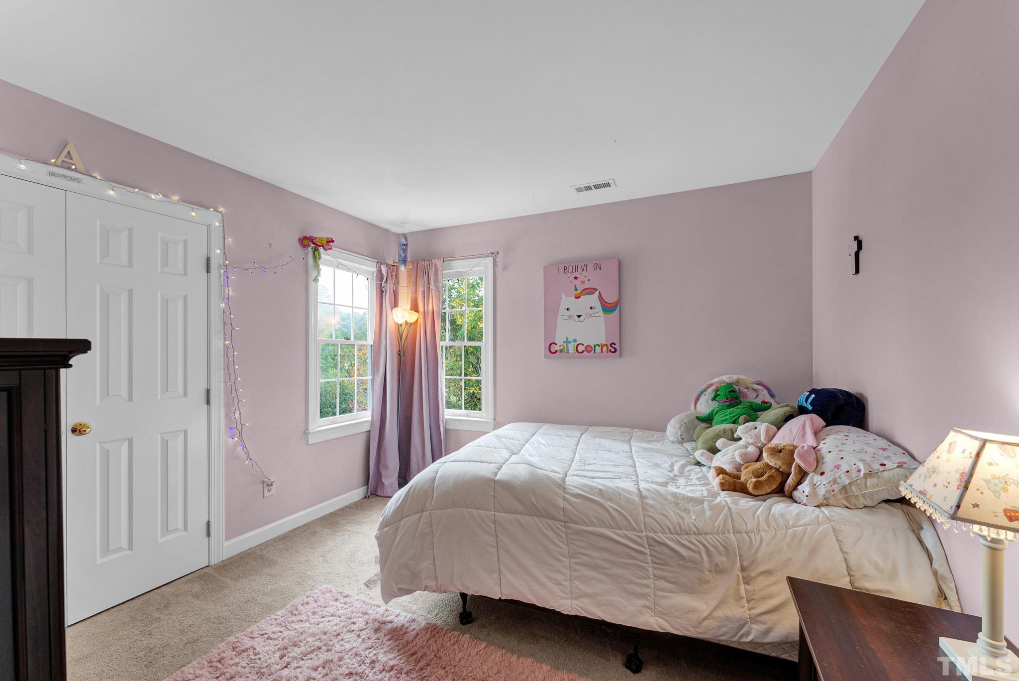 11619 Shavenrock Place Raleigh, NC 27613 - Photo 18 of 20 a bedroom with a bed and large window