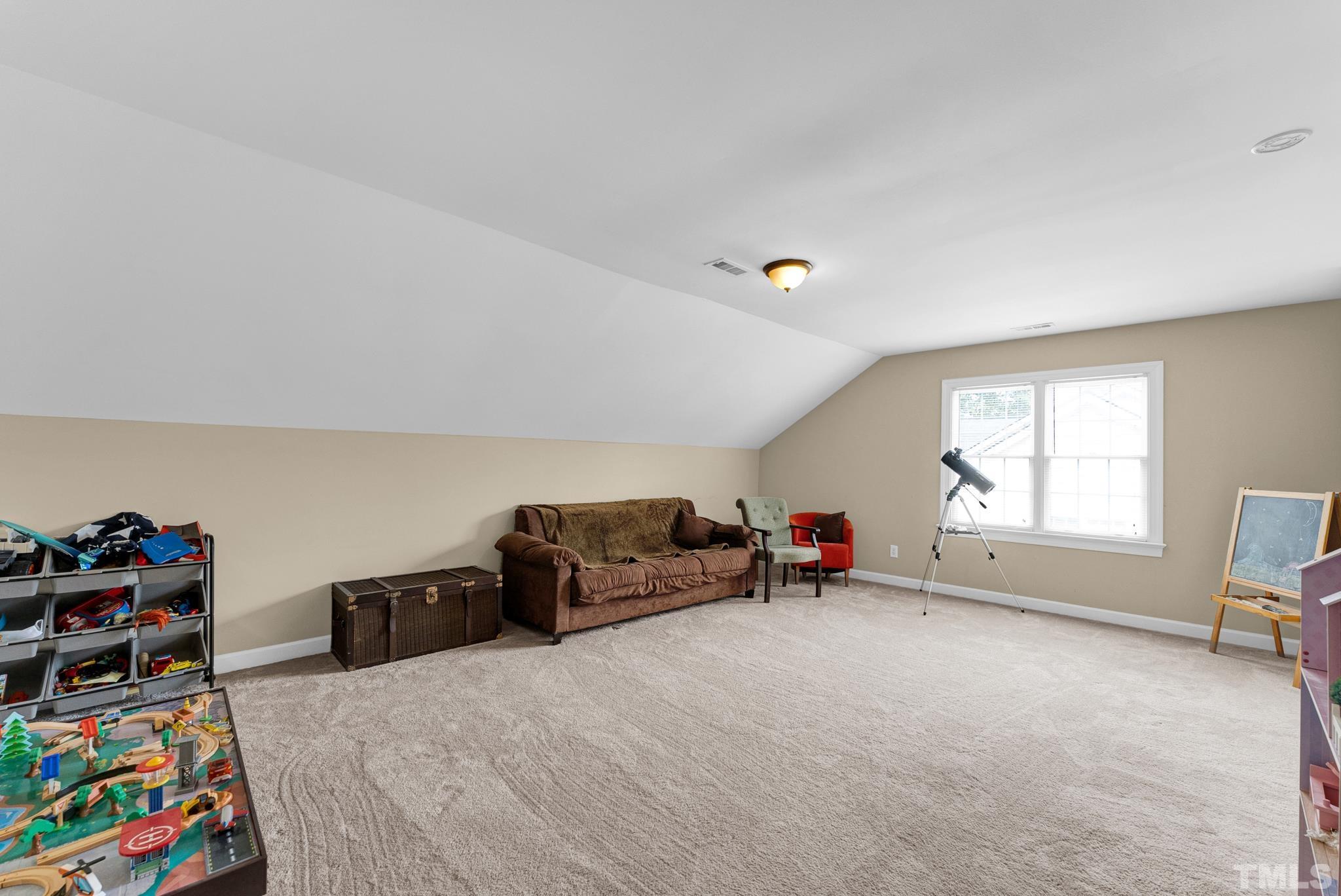 11619 Shavenrock Place Raleigh, NC 27613 - Photo 19 of 20 a living room with furniture and a window
