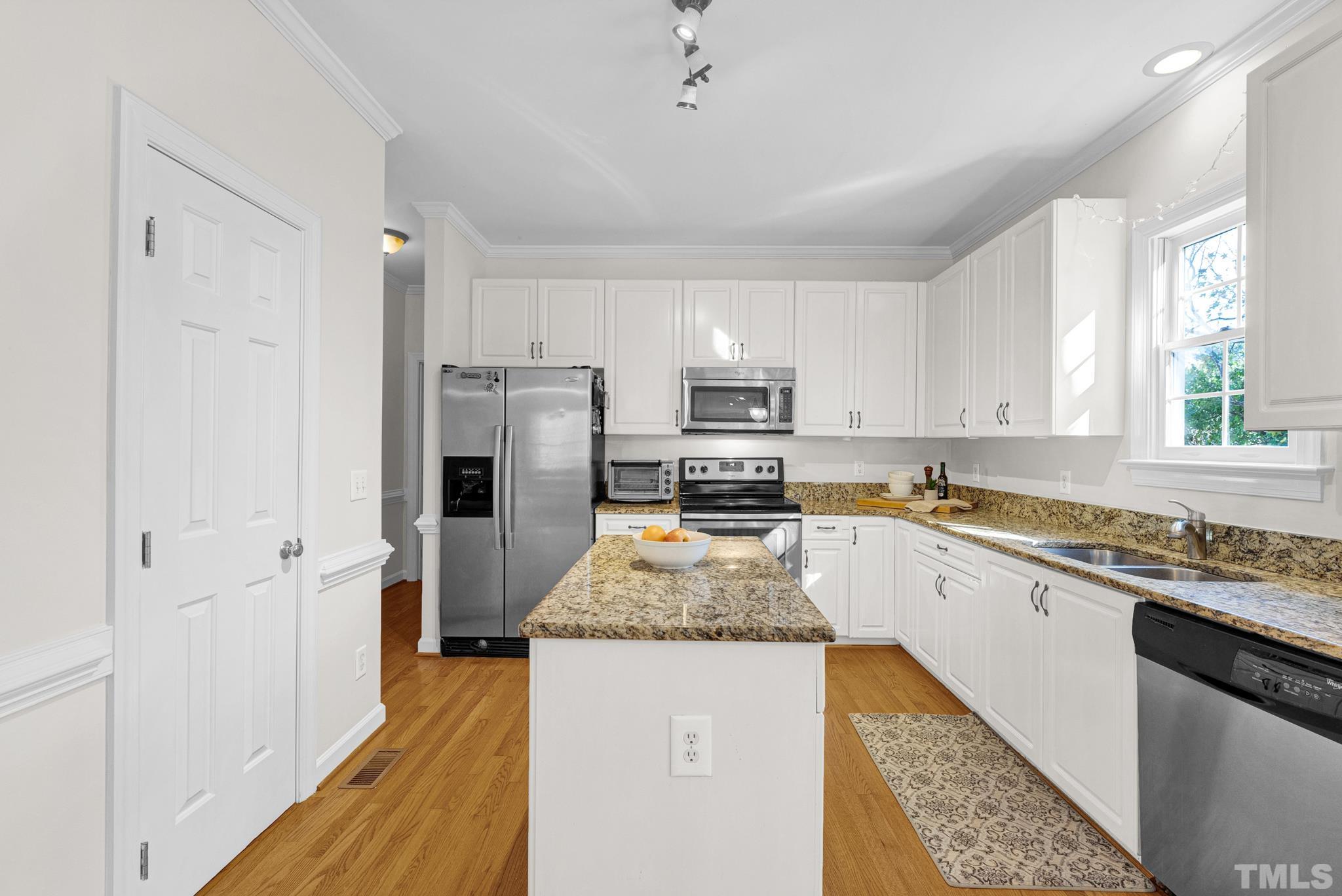 11619 Shavenrock Place Raleigh, NC 27613 - Photo 3 of 20 a kitchen with granite countertop stainless steel appliances a refrigerator sink and microwave
