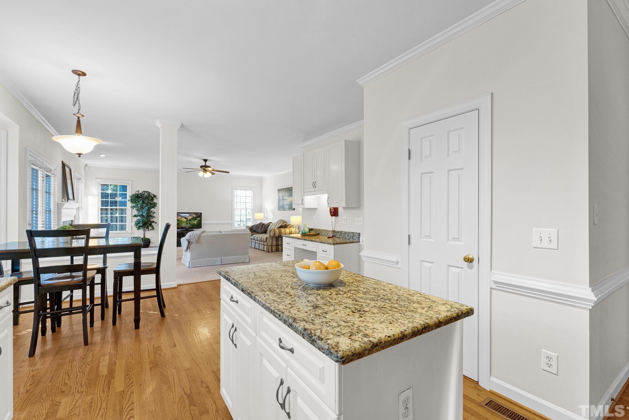 11619 Shavenrock Place Raleigh, NC 27613 - Photo 4 of 20 a kitchen with a table chairs and wooden floor