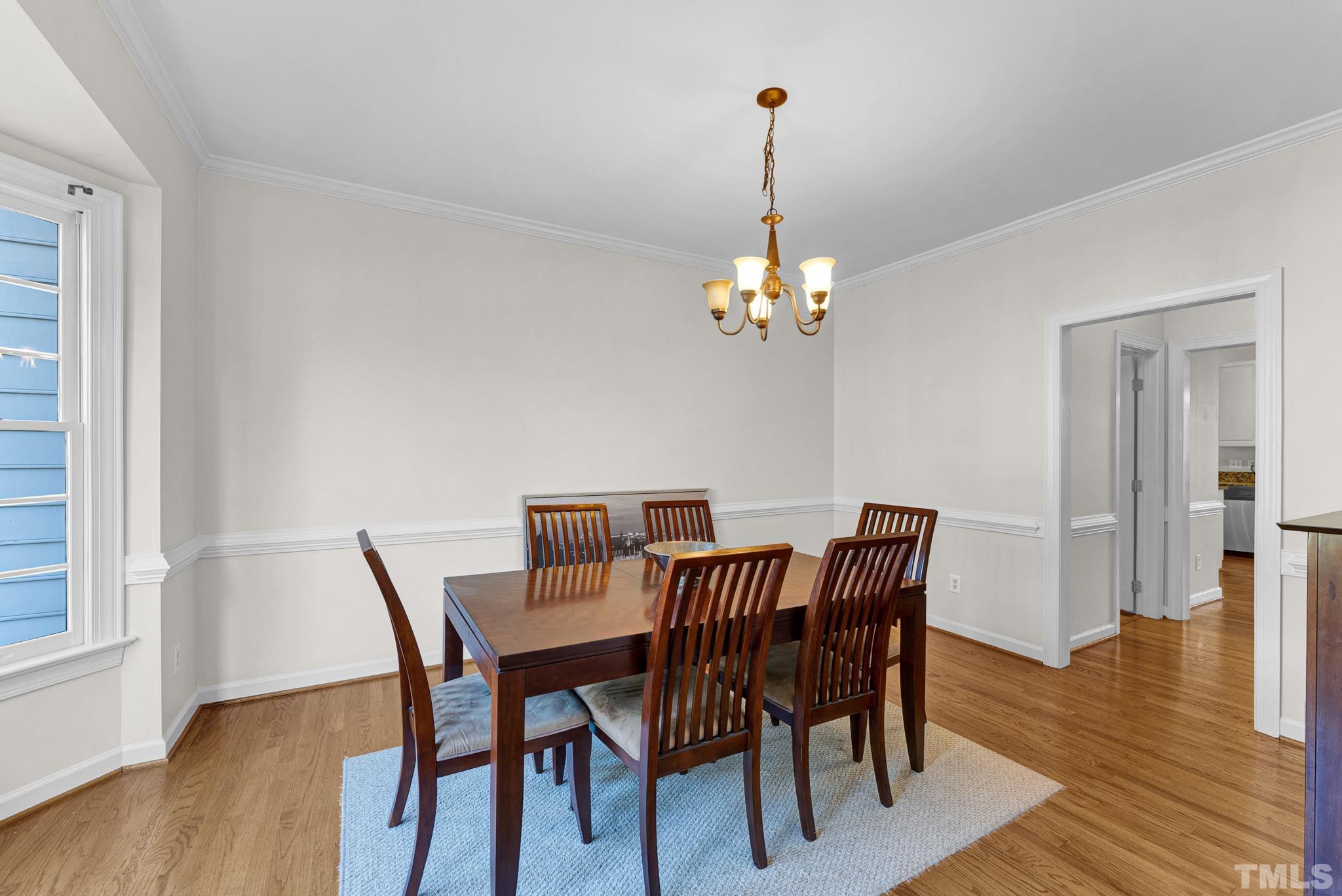 11619 Shavenrock Place Raleigh, NC 27613 - Photo 5 of 20 a view of a dining room with furniture wooden floor and chandelier