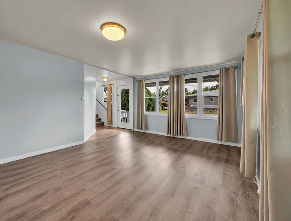 a view of a hallway with wooden floor and entryway