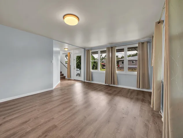 a view of a hallway with wooden floor and entryway