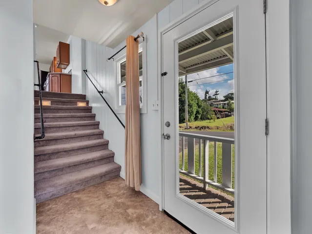 a large kitchen with stainless steel appliances kitchen island granite countertop a refrigerator and a stove top oven