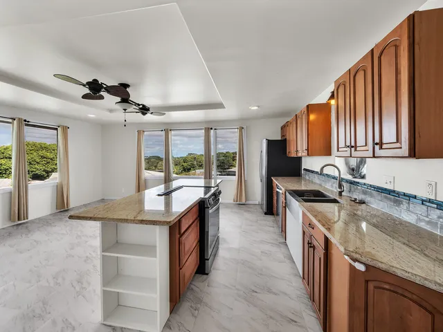 a kitchen with granite countertop a stove and a sink