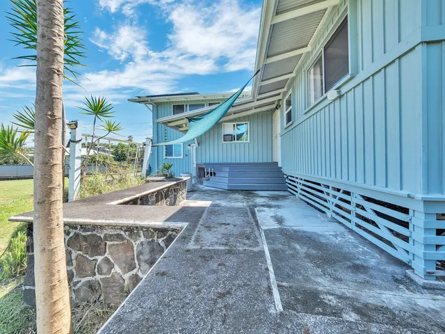 a view of a backyard with swimming pool