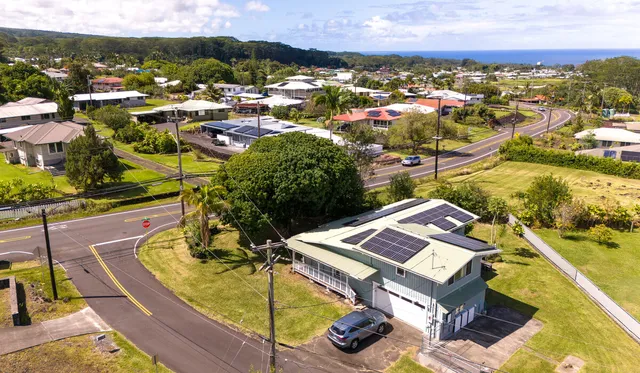 an aerial view of a house with a yard
