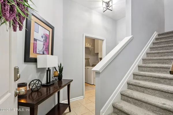 a living room with furniture and a entryway